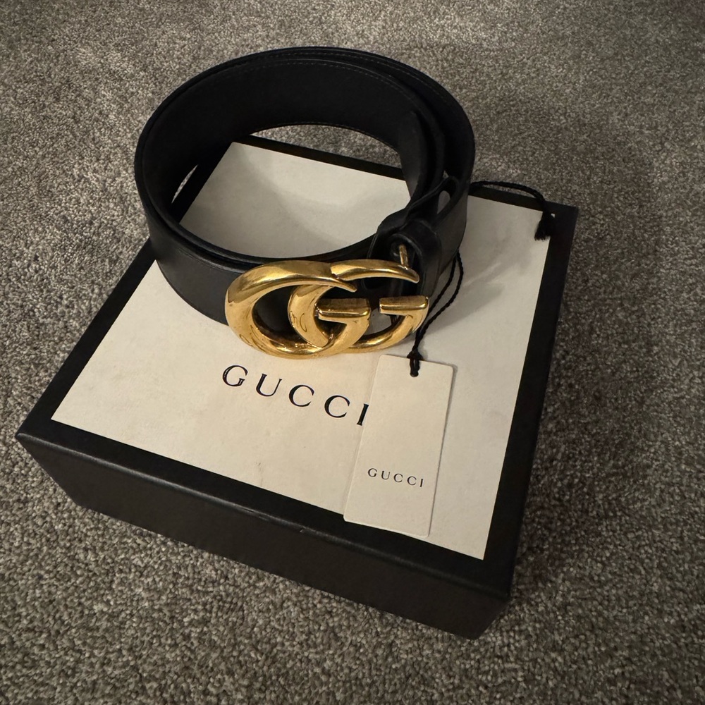 Black and gold Gucci belt
